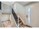 Welcoming entryway with wood stairs and modern black metal railing detail, creating an elegant entrance at 1152 S Salida Way, Aurora, CO 80017