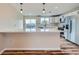 Bright kitchen with white cabinets, stainless steel appliances, a large island, and modern pendant lighting at 1152 S Salida Way, Aurora, CO 80017