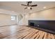 Finished basement featuring a black brick fireplace, recessed lighting, wood-look floors, and a staircase at 1152 S Salida Way, Aurora, CO 80017