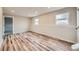 Spacious living room featuring neutral paint, wood-look floors, and natural light from multiple windows at 1152 S Salida Way, Aurora, CO 80017
