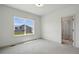 This bedroom features carpet, a window, and view to en-suite bathroom at 260 E 4Th St, Berthoud, CO 80513
