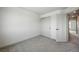 This bedroom features neutral carpet, a closet and white walls at 260 E 4Th St, Berthoud, CO 80513
