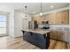 Modern kitchen with stainless steel appliances, granite countertops, and a dark wood island at 260 E 4Th St, Berthoud, CO 80513