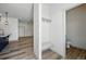 Bright mudroom with a bench and hooks, connecting to a half bathroom and spacious living area at 260 E 4Th St, Berthoud, CO 80513