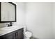 Compact powder room with a modern vanity, white countertop, and toilet at 260 E 4Th St, Berthoud, CO 80513