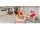 Finished basement has a large recreational area with comfortable seating and a drum set at 890 S Vine St, Denver, CO 80209