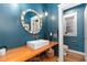 Charming powder room features a decorative mirror, unique wooden sink counter, and toilet room at 890 S Vine St, Denver, CO 80209
