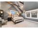 Cozy bedroom offers a soft carpet, exposed ceiling beams, and lots of natural light from the multiple windows at 890 S Vine St, Denver, CO 80209