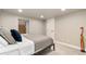 Basement bedroom with a neutral color palette, egress window, and cozy decor at 890 S Vine St, Denver, CO 80209