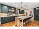 Modern kitchen with sleek cabinets, stone countertops, stainless steel appliances, and center island at 890 S Vine St, Denver, CO 80209