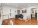 Inviting living room features hardwood floors, neutral decor, and lots of natural light from the large windows at 890 S Vine St, Denver, CO 80209