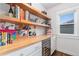 Well-organized pantry with custom shelving, countertops, and a wine refrigerator at 890 S Vine St, Denver, CO 80209
