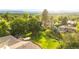 Aerial view of the property reveals large backyard, deck, and lush green landscape at 41 Skyline Dr, Wheat Ridge, CO 80215