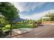 Spacious backyard with a wooden deck, lush lawn, and mature trees at 41 Skyline Dr, Wheat Ridge, CO 80215