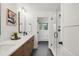 Modern bathroom featuring dual sinks, wood cabinets, and a glass-enclosed shower at 41 Skyline Dr, Wheat Ridge, CO 80215