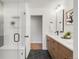 Sleek bathroom featuring dual vanities, wood cabinets, and a glass shower at 41 Skyline Dr, Wheat Ridge, CO 80215