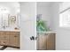 Split view of a bathroom featuring neutral-toned vanities with live greenery at 41 Skyline Dr, Wheat Ridge, CO 80215