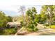 Charming home with well-maintained landscaping and mature trees lining the front yard at 41 Skyline Dr, Wheat Ridge, CO 80215