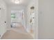Bright hallway with carpeted floors, leading to a bedroom and bathroom with tiled floors at 41 Skyline Dr, Wheat Ridge, CO 80215