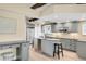 Gorgeous kitchen with stainless appliances, granite counters, an eat-in island and modern lighting at 41 Skyline Dr, Wheat Ridge, CO 80215