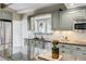 Well-lit kitchen featuring stainless steel appliances, stone countertops, and gray cabinetry at 41 Skyline Dr, Wheat Ridge, CO 80215