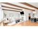 Bright living room with hardwood floors, a fireplace, and seamless transition to dining at 41 Skyline Dr, Wheat Ridge, CO 80215