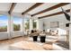 Sunlit living area featuring hardwood floors, neutral decor, and a wall of windows with views at 41 Skyline Dr, Wheat Ridge, CO 80215
