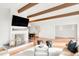 Open-concept living area with fireplace, TV, and clear sightlines into the dining room at 41 Skyline Dr, Wheat Ridge, CO 80215
