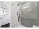 Modern glass shower with gray tile, black fixtures, and a rain shower head at 41 Skyline Dr, Wheat Ridge, CO 80215