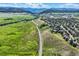 Stunning aerial view of winding roads through rolling hills and a neighborhood surrounded by nature at 8915 S Field Ct, Littleton, CO 80128