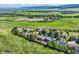 Scenic aerial view of homes surrounded by lush green fields and mountains in the distance at 8915 S Field Ct, Littleton, CO 80128