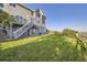 A lush green backyard with a well-maintained lawn, complemented by a beautiful home exterior and a wooden fence at 8915 S Field Ct, Littleton, CO 80128