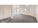 Finished basement with recessed lighting, carpeted floor, large windows and access to the outside at 8915 S Field Ct, Littleton, CO 80128