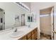 Well-lit bathroom with a double sink vanity, large mirror and separate tub and shower at 8915 S Field Ct, Littleton, CO 80128