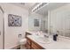 Bright bathroom featuring a single sink vanity, a toilet, and a shower with glass doors at 8915 S Field Ct, Littleton, CO 80128
