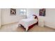 Cozy bedroom featuring neutral carpet, a bright window and colorful wall art at 8915 S Field Ct, Littleton, CO 80128