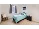 Cozy bedroom with neutral carpet, window, and simple furnishings at 8915 S Field Ct, Littleton, CO 80128