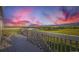 Enjoy expansive views from this spacious deck with scenic landscape and colorful skies at dusk at 8915 S Field Ct, Littleton, CO 80128