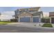 Two-story home featuring a spacious three-car garage with a stone facade at 8915 S Field Ct, Littleton, CO 80128