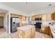 Well-lit kitchen featuring an island, stainless steel appliances, and ample cabinet space at 8915 S Field Ct, Littleton, CO 80128