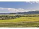 Scenic landscape view showcases rolling hills and a sprawling green field, complementing the home's natural surroundings at 8915 S Field Ct, Littleton, CO 80128