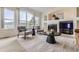 Cozy living room with a fireplace, neutral decor, and a large picture window at 8915 S Field Ct, Littleton, CO 80128