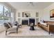 Comfortable living room with fireplace, modern decor, and large windows at 8915 S Field Ct, Littleton, CO 80128