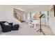 Inviting living room with a piano, large windows and an adjacent stairway at 8915 S Field Ct, Littleton, CO 80128