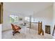 Open loft area with a desk, chair, and beautiful views from two windows at 8915 S Field Ct, Littleton, CO 80128