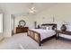 Primary bedroom features an accent wall, ceiling fan, and soft natural light at 8915 S Field Ct, Littleton, CO 80128