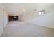 Large finished basement featuring a brick fireplace, neutral carpeting, and bright, painted walls at 12024 W Maryland Dr, Lakewood, CO 80228