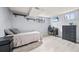 Basement bedroom with a bed, desk and chair, dresser, and light-colored wood floors at 12024 W Maryland Dr, Lakewood, CO 80228