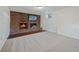 Finished basement with a brick fireplace, neutral carpeting, and updated lighting at 12024 W Maryland Dr, Lakewood, CO 80228