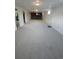 Spacious basement featuring carpeting, white walls, and a dark brick fireplace at 12024 W Maryland Dr, Lakewood, CO 80228